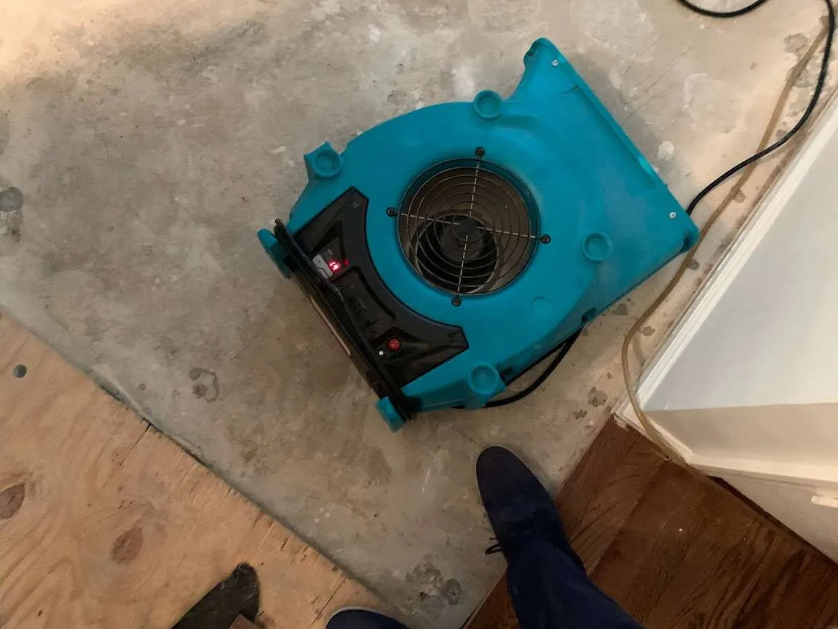 Air mover drying subfloor during Commercial Water Damage Restoration in Oakwood